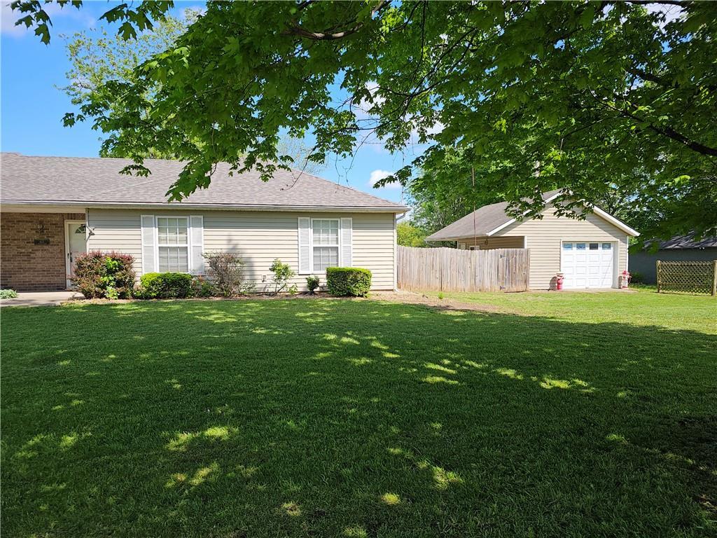 exterior space with a detached garage and fence