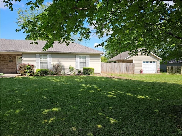 exterior space with a detached garage and fence
