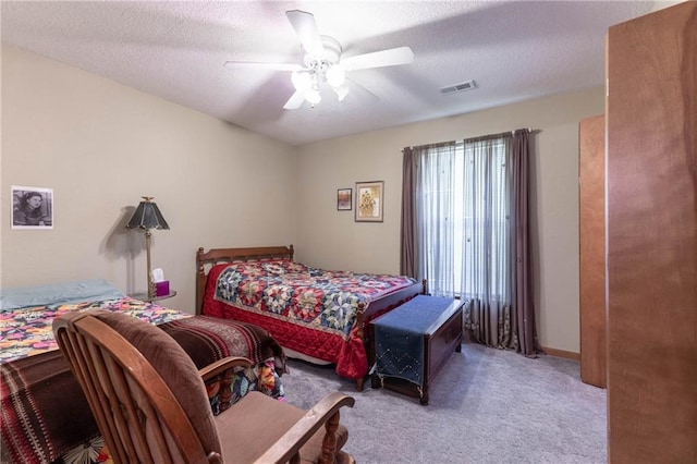 403 S 2nd St, Drexel, MO 64742 - carpeted bedroom with a textured ceiling, visible vents, and a ceiling fan