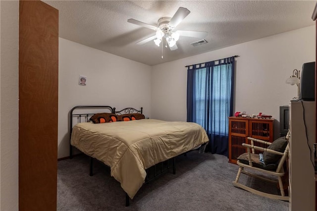 403 S 2nd St, Drexel, MO 64742 - carpeted bedroom with a textured ceiling, a ceiling fan, and visible vents
