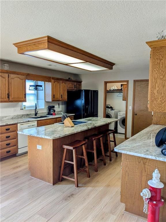 403 S 2nd St, Drexel, MO 64742 - kitchen featuring black refrigerator with ice dispenser, white dishwasher, a sink, a textured ceiling, and separate washer and dryer