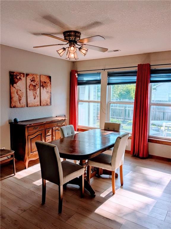 403 S 2nd St, Drexel, MO 64742 - dining space featuring a textured ceiling, light wood-style flooring, and ceiling fan