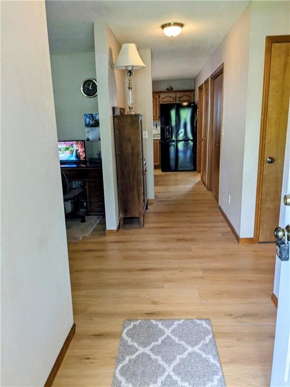 403 S 2nd St, Drexel, MO 64742 - hall with baseboards and light wood-style floors