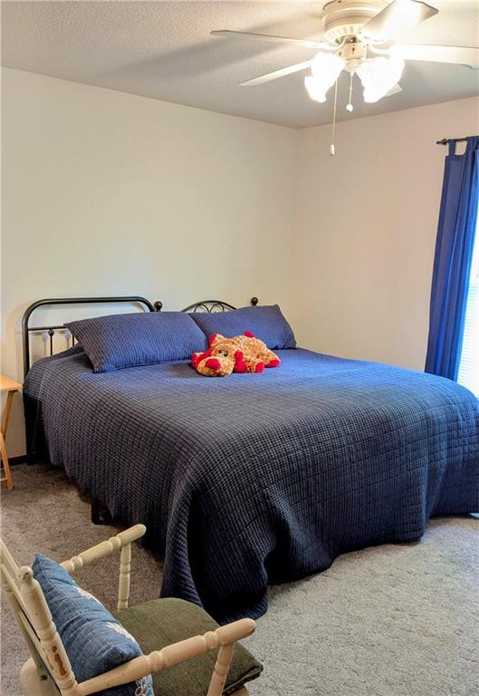 403 S 2nd St, Drexel, MO 64742 - carpeted bedroom featuring a ceiling fan