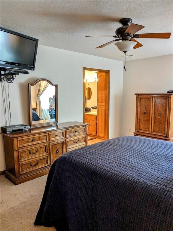 403 S 2nd St, Drexel, MO 64742 - bedroom with light carpet, ceiling fan, ensuite bath, and a textured ceiling