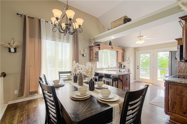 5912 NE Hidden Valley Dr, Lees Summit, MO 64064 - dining space with vaulted ceiling, wood finished floors, a chandelier, ceiling fan, and baseboards