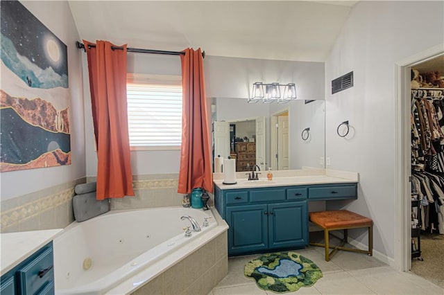5912 NE Hidden Valley Dr, Lees Summit, MO 64064 - bathroom with vanity, a whirlpool tub, a walk in closet, and tile patterned flooring