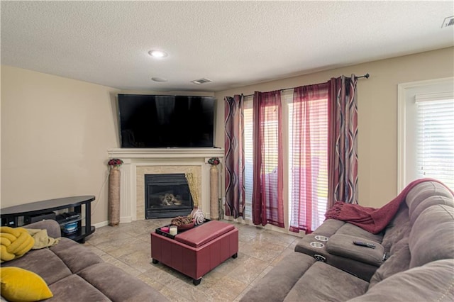 5912 NE Hidden Valley Dr, Lees Summit, MO 64064 - living room with a textured ceiling, healthy amount of natural light, a premium fireplace, and baseboards