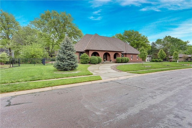 9000 W 104th St, Overland Park, KS 66212 - view of front facade featuring fence, driveway, and a front lawn