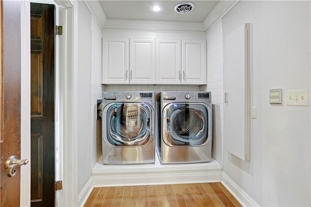 9000 W 104th St, Overland Park, KS 66212 - washroom with baseboards, cabinet space, wood finished floors, and washer and dryer