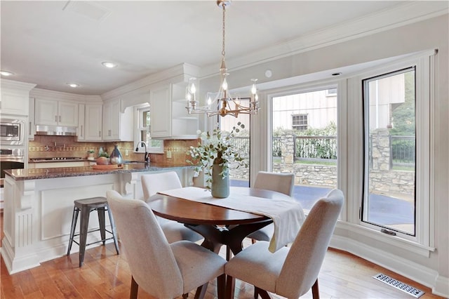 9000 W 104th St, Overland Park, KS 66212 - dining space featuring a notable chandelier, visible vents, and a healthy amount of sunlight