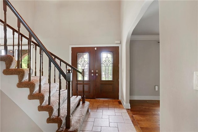 9000 W 104th St, Overland Park, KS 66212 - entryway featuring stairway, baseboards, arched walkways, and stone tile flooring
