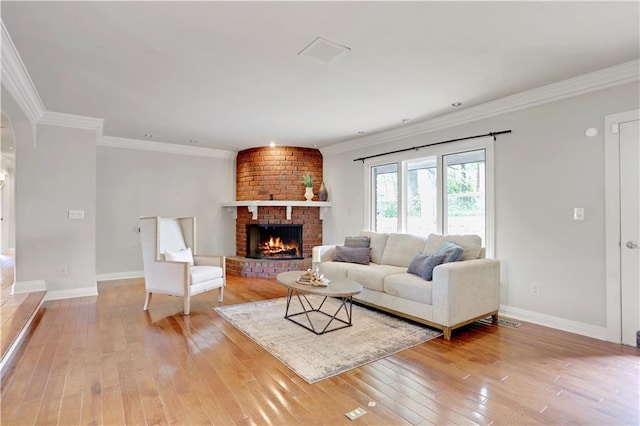 9000 W 104th St, Overland Park, KS 66212 - living area with arched walkways, baseboards, a fireplace, and light wood finished floors