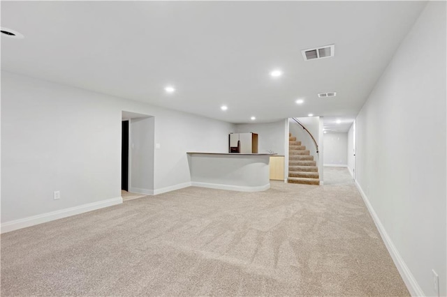 9000 W 104th St, Overland Park, KS 66212 - unfurnished living room featuring stairway, light carpet, recessed lighting, and visible vents