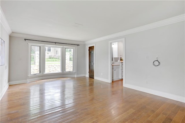 9000 W 104th St, Overland Park, KS 66212 - unfurnished living room with crown molding, baseboards, and light wood finished floors