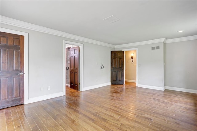 9000 W 104th St, Overland Park, KS 66212 - spare room featuring crown molding, light wood-style floors, recessed lighting, baseboards, and visible vents