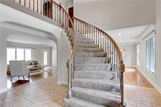 9000 W 104th St, Overland Park, KS 66212 - stairs with crown molding, arched walkways, baseboards, recessed lighting, and stone tile floors