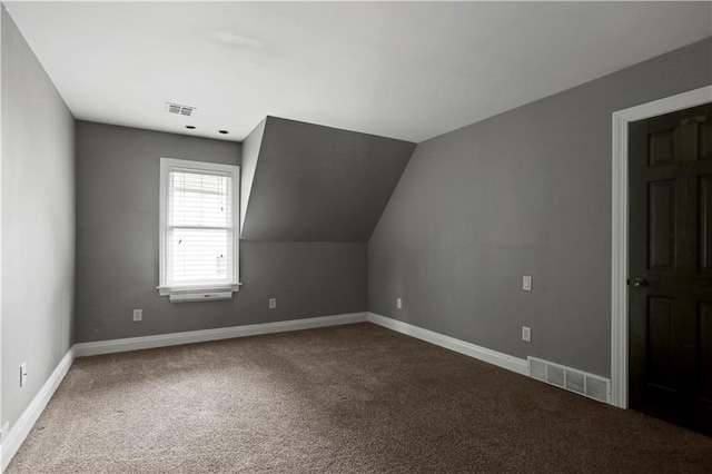 9000 W 104th St, Overland Park, KS 66212 - additional living space featuring vaulted ceiling, baseboards, carpet flooring, and visible vents