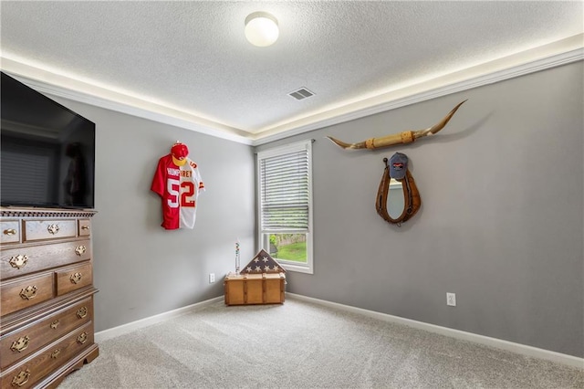 bedroom with carpet flooring, a textured ceiling, visible vents, and baseboards