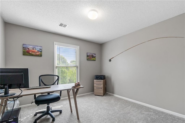 office featuring carpet floors, baseboards, a textured ceiling, and visible vents
