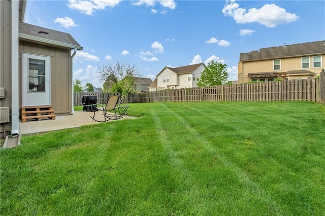 view of yard with a fenced backyard, a patio area, and entry steps