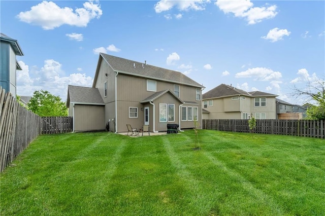 rear view of property with a fenced backyard, a patio, and a lawn