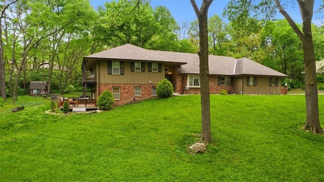 606 W Red Bridge Rd, Kansas City, MO 64114 - back of property featuring a lawn, a wooden deck, a balcony, and brick siding