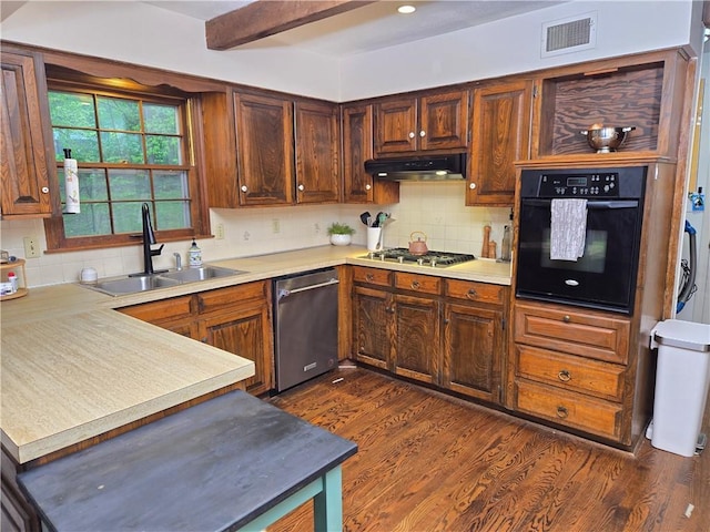 606 W Red Bridge Rd, Kansas City, MO 64114 - kitchen with a sink, light countertops, stainless steel appliances, under cabinet range hood, and visible vents