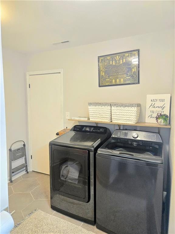606 W Red Bridge Rd, Kansas City, MO 64114 - laundry room featuring tile patterned flooring, laundry area, and washing machine and dryer