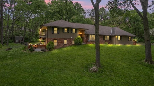 606 W Red Bridge Rd, Kansas City, MO 64114 - view of front of property featuring a yard, a deck, brick siding, and an outbuilding