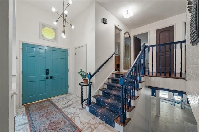 606 W Red Bridge Rd, Kansas City, MO 64114 - foyer entrance featuring stairway and a chandelier