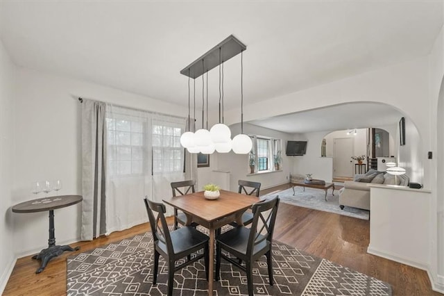 606 W Red Bridge Rd, Kansas City, MO 64114 - dining area featuring arched walkways and wood finished floors