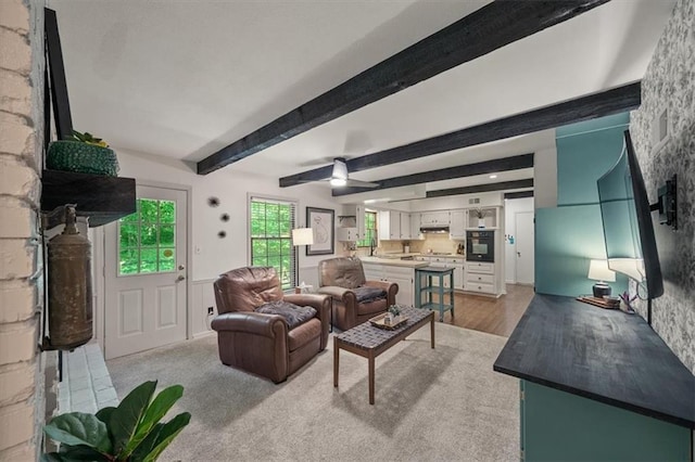 606 W Red Bridge Rd, Kansas City, MO 64114 - living room featuring beamed ceiling and light wood-style floors