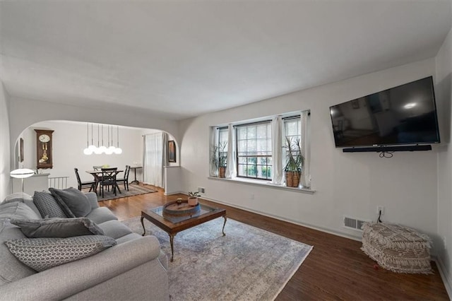 606 W Red Bridge Rd, Kansas City, MO 64114 - living room with arched walkways and wood finished floors