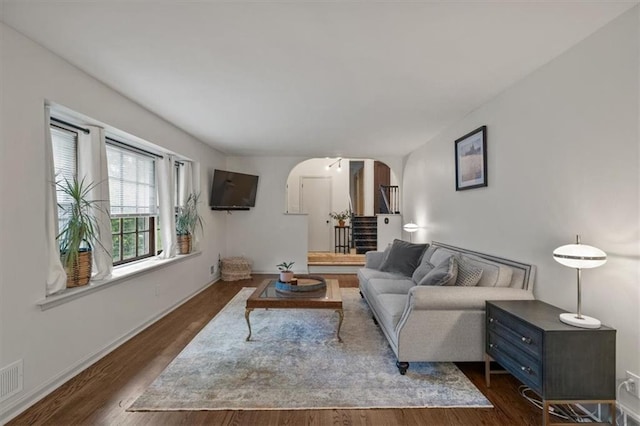 606 W Red Bridge Rd, Kansas City, MO 64114 - living area with arched walkways and dark wood-style floors