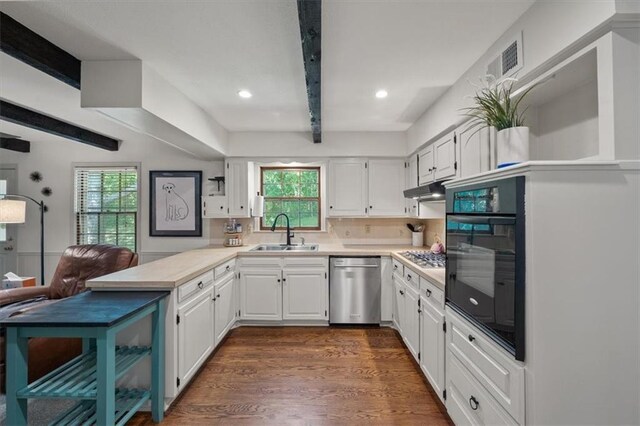 606 W Red Bridge Rd, Kansas City, MO 64114 - kitchen featuring dishwasher, black oven, a peninsula, light countertops, and beam ceiling