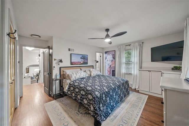 606 W Red Bridge Rd, Kansas City, MO 64114 - bedroom featuring wood finished floors, arched walkways, and ceiling fan