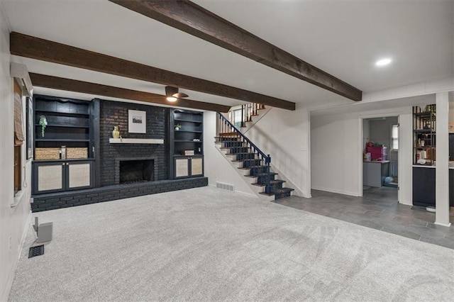 606 W Red Bridge Rd, Kansas City, MO 64114 - unfurnished living room with beamed ceiling, stairway, carpet, and a brick fireplace
