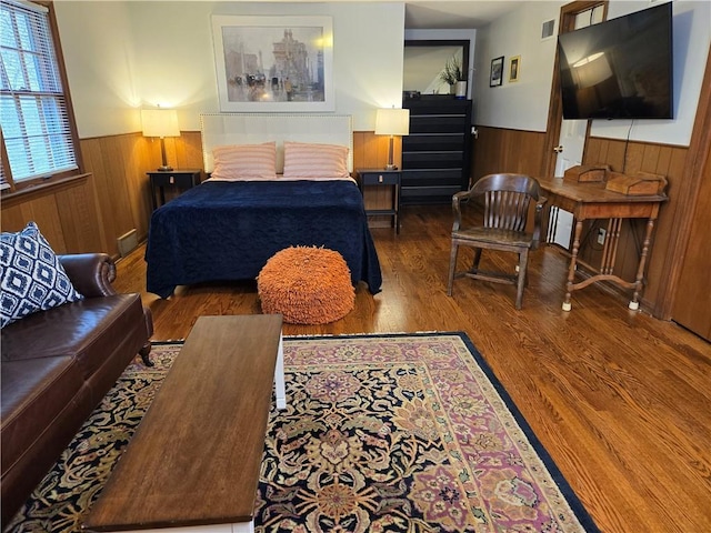 606 W Red Bridge Rd, Kansas City, MO 64114 - bedroom featuring wainscoting, wooden walls, and wood finished floors