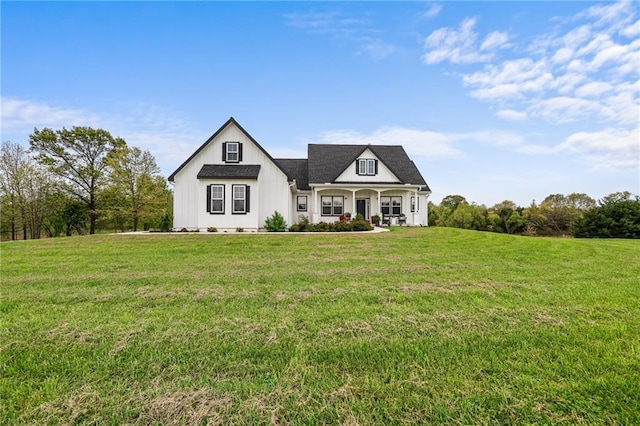 modern farmhouse style home featuring a porch and a front yard