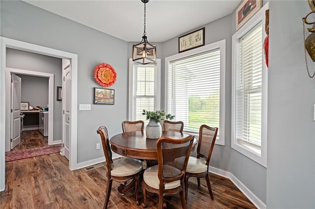 dining area featuring baseboards, dark wood finished floors, and visible vents