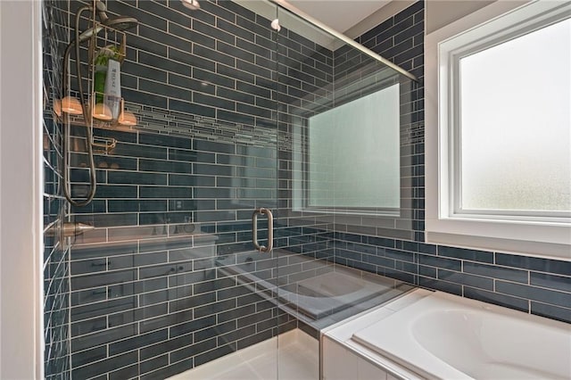 bathroom featuring backsplash, a garden tub, and a stall shower