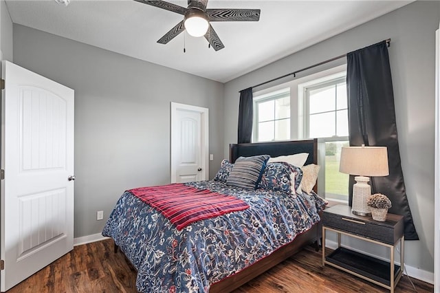 bedroom featuring baseboards, a ceiling fan, and wood finished floors