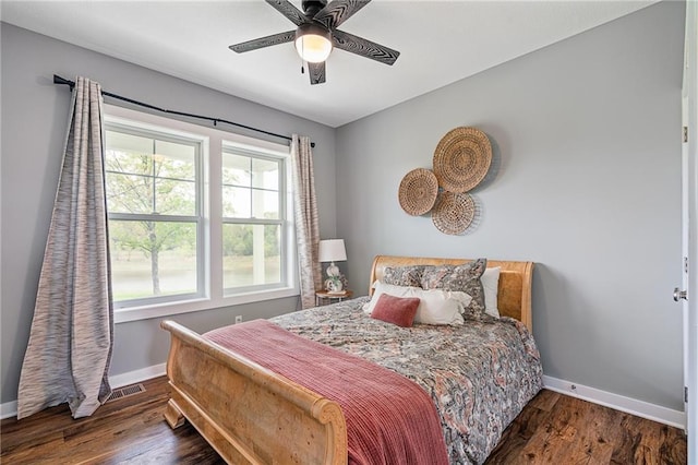 bedroom featuring baseboards, a ceiling fan, and wood finished floors