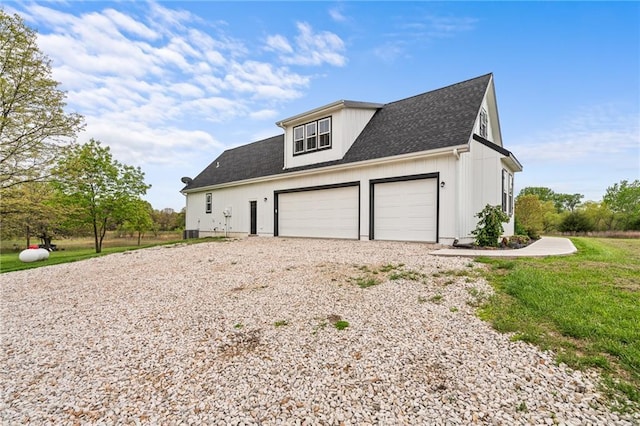 garage featuring central AC and gravel driveway