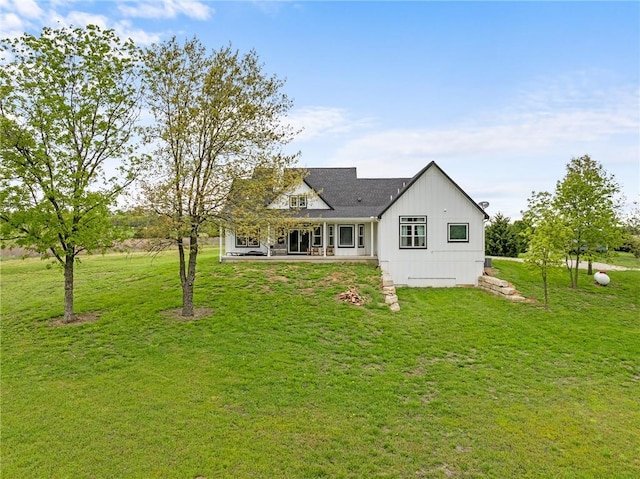 rear view of property featuring a lawn and a patio