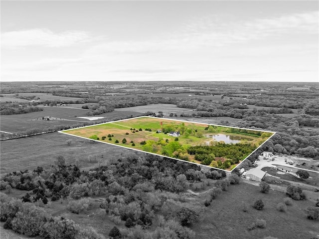 birds eye view of property featuring a water view and a rural view