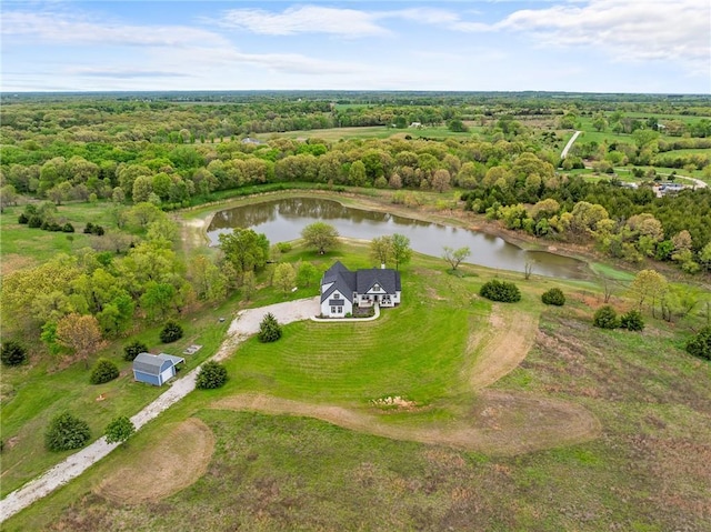 aerial view with a water view and a forest view
