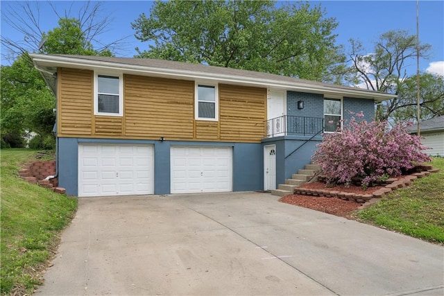  - view of front of home with a garage, stairs, and driveway