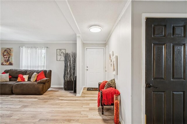  - entryway featuring crown molding, baseboards, and wood finished floors
